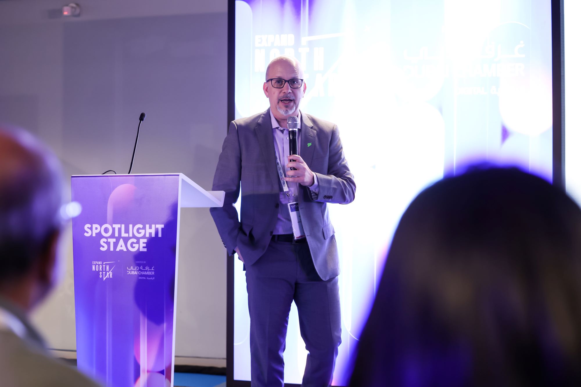 A speaker addressing the audience on the Expand North Star Spotlight Stage